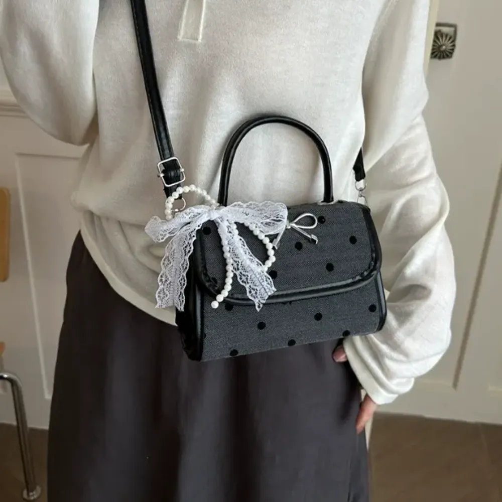 Woman carrying black crossbody bag