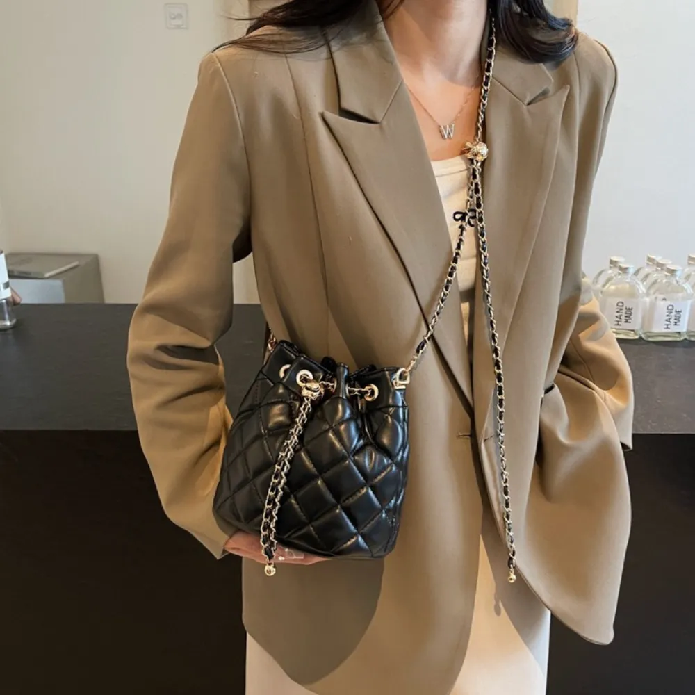 Woman wearing a black textured crossbody bag
