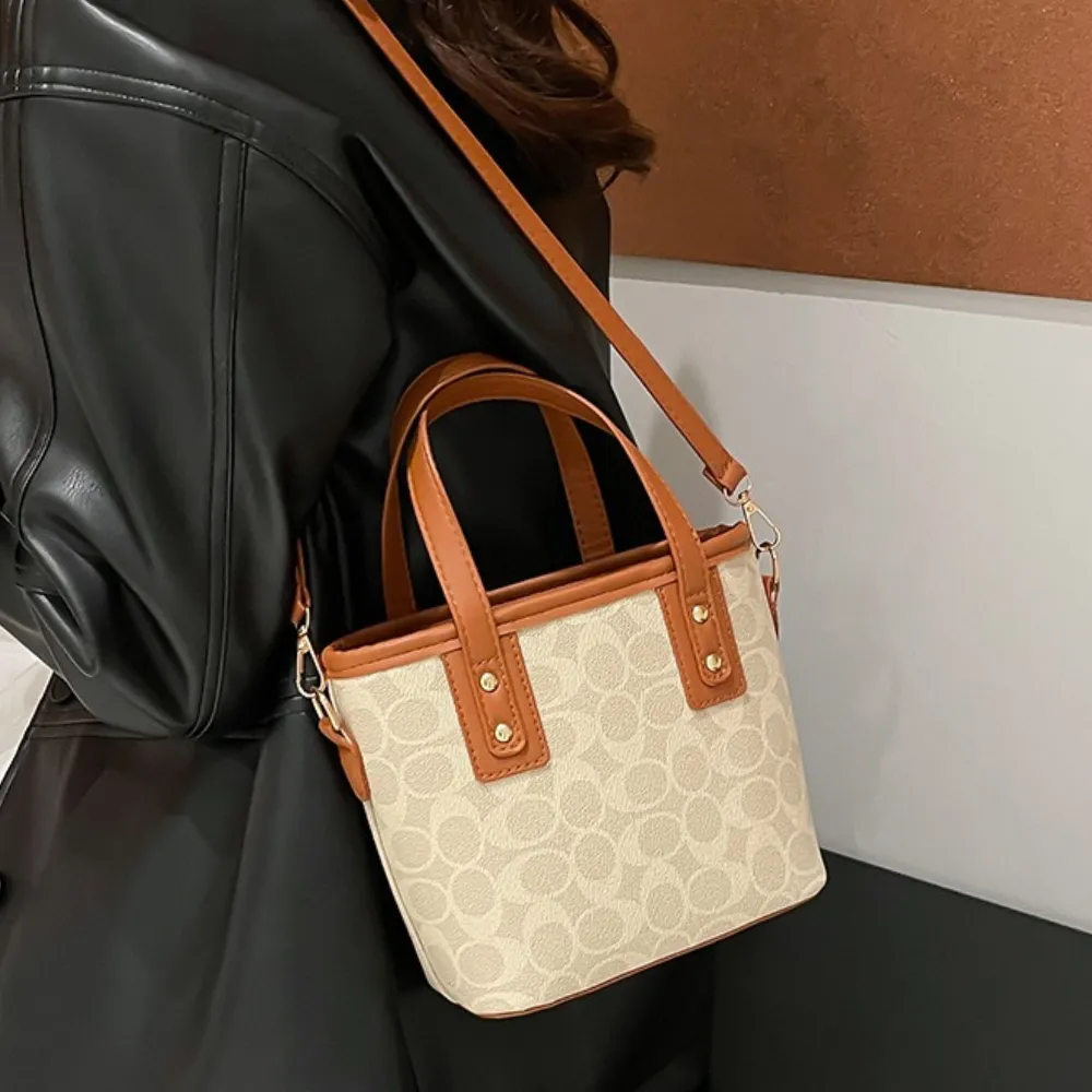 Beige crossbody bag worn over the shoulder