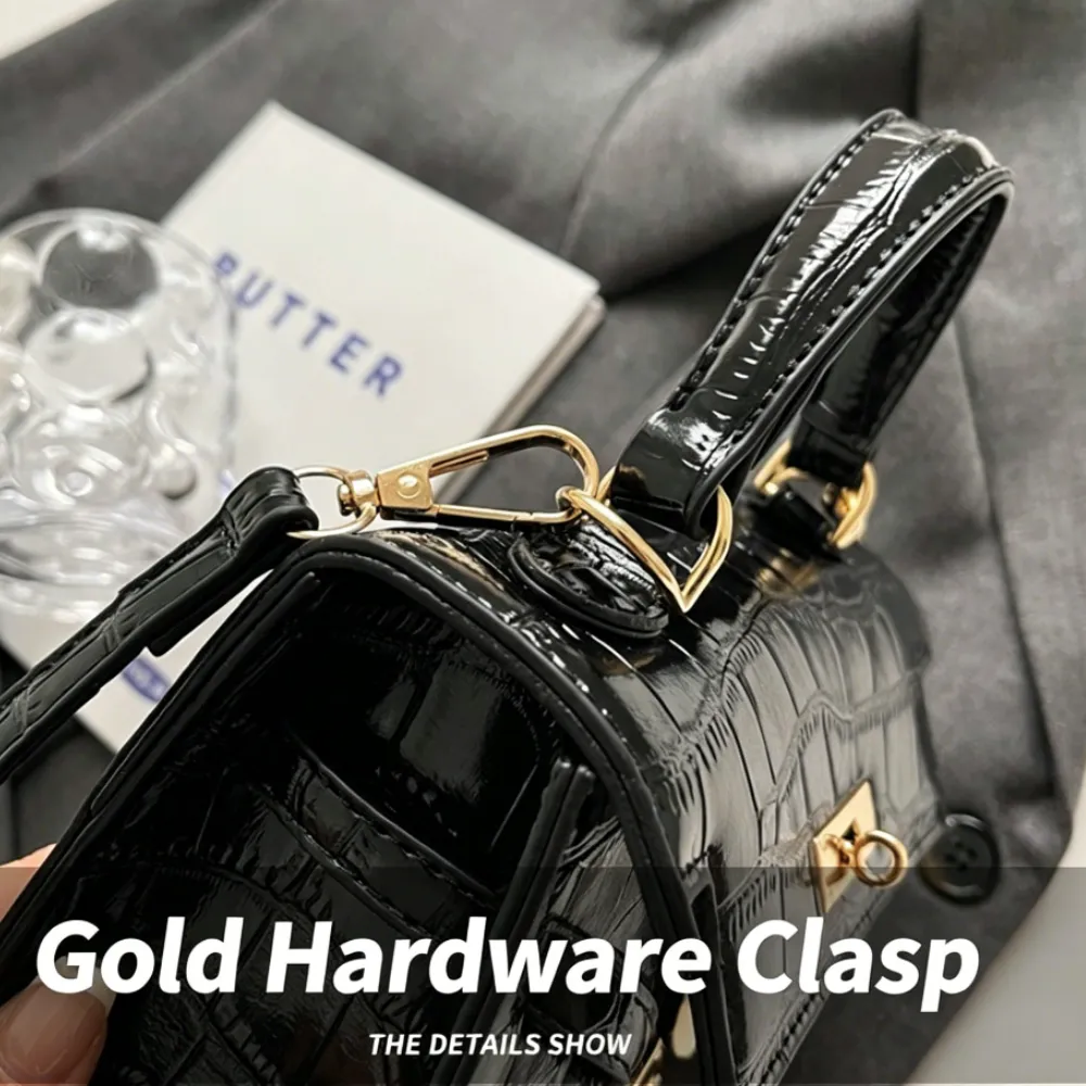 Black crossbody bag with gold hardware clasp