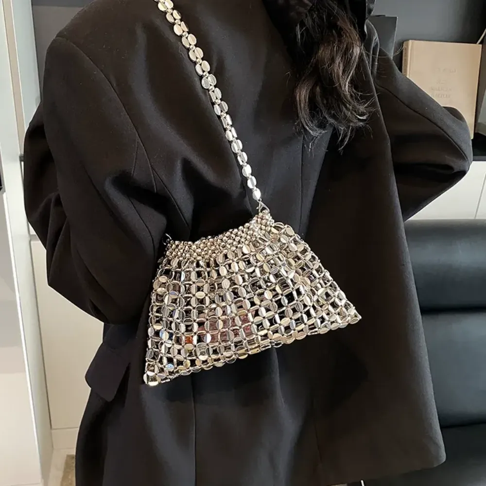 Silver crystal crossbody bag worn by a woman