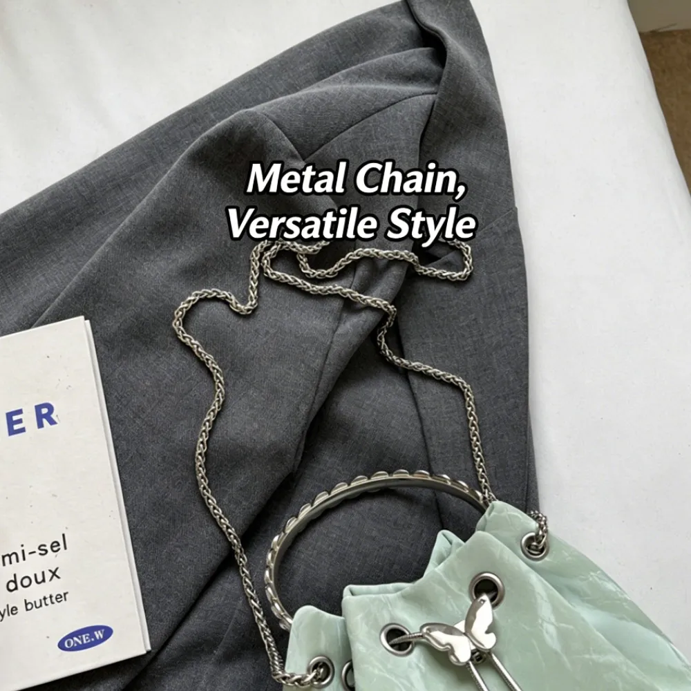 Mint green drawstring crossbody bag with metal chain