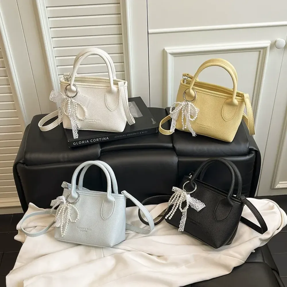 PU handbags with pearl bows in yellow blue white and black