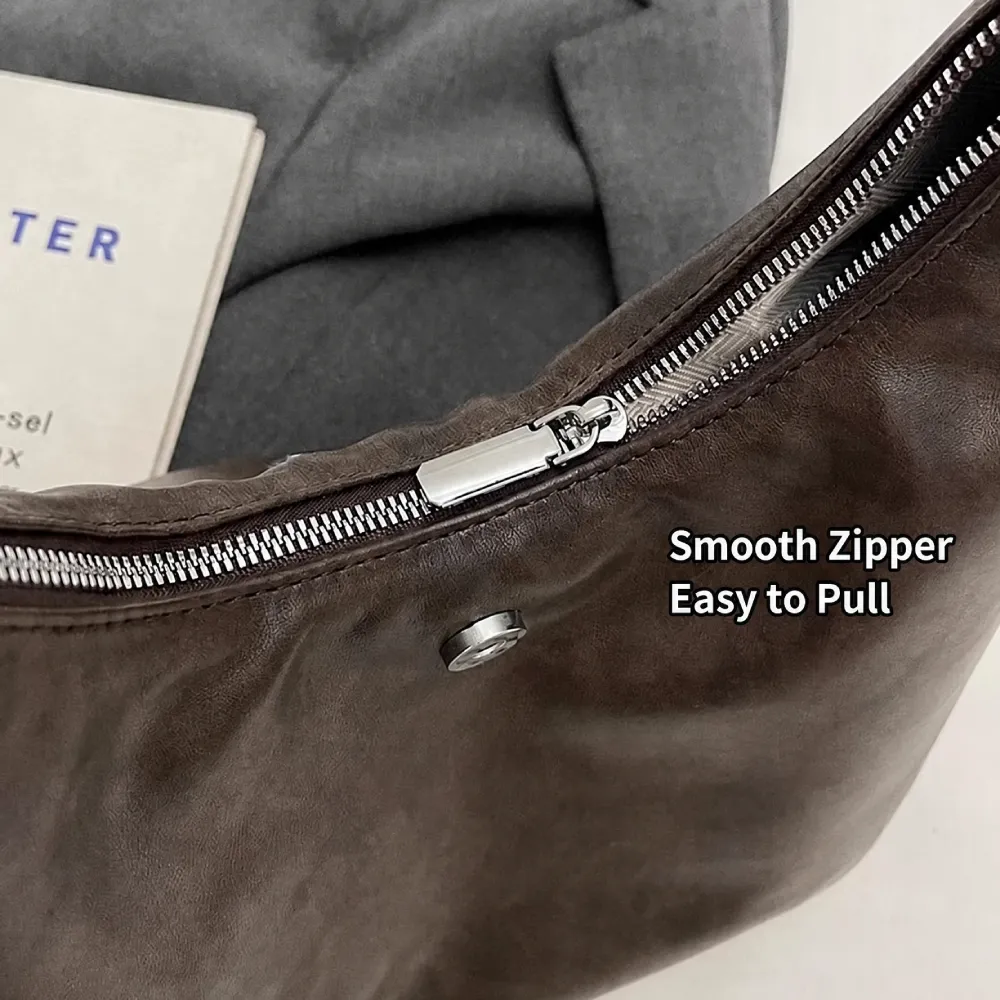 smooth zipper pull detail on leather handbag for women