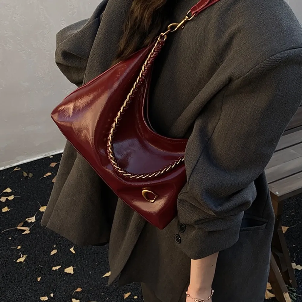 Woman wearing a red leather shoulder bag