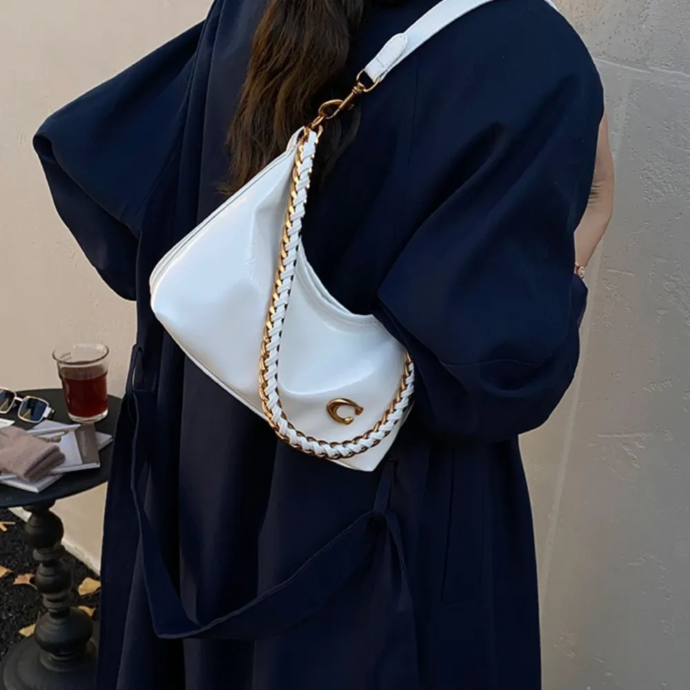 White shoulder bag worn by woman