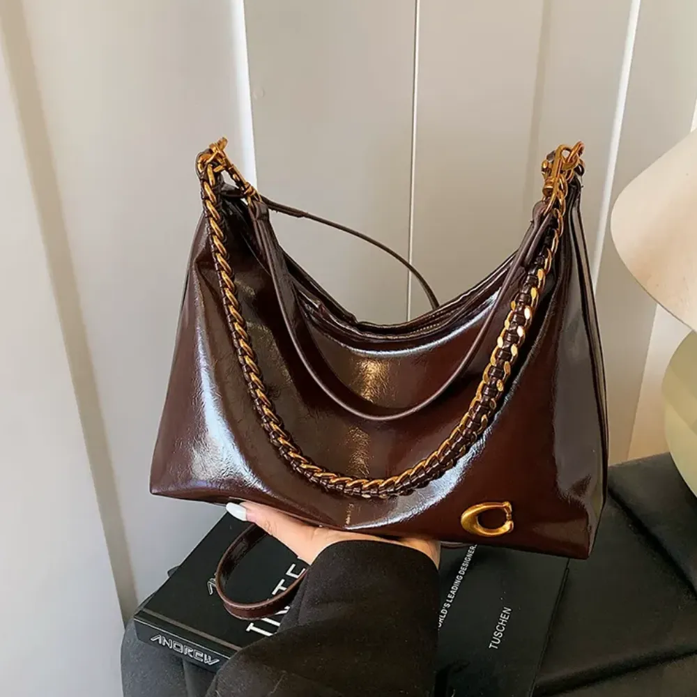 Brown leather shoulder bag worn over the shoulder