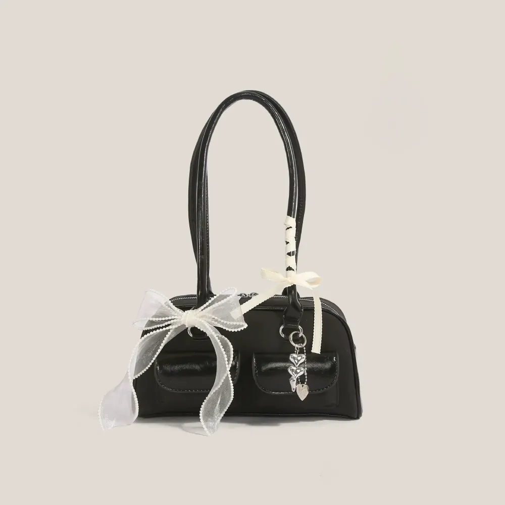 Black bow-decorated shoulder bag with heart charm
