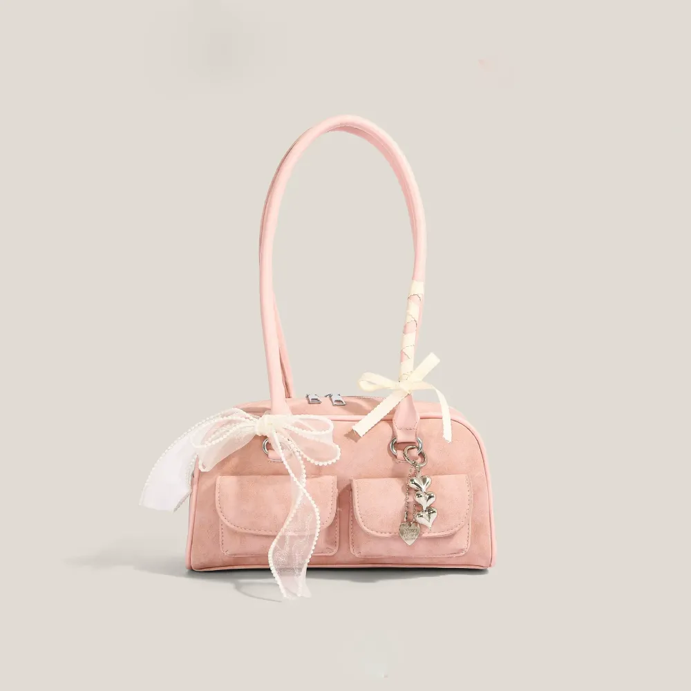 Pink bow-decorated shoulder bag with heart charm