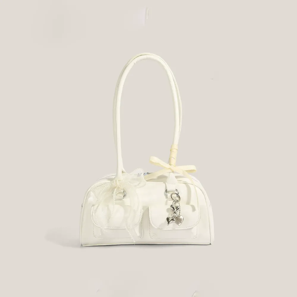 Withe bow shoulder bag with heart-shaped charm