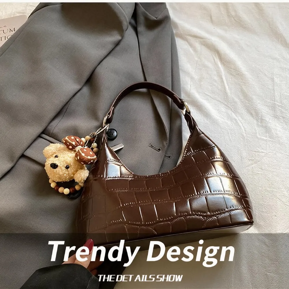 Brown textured handbag with teddy bear charm for women