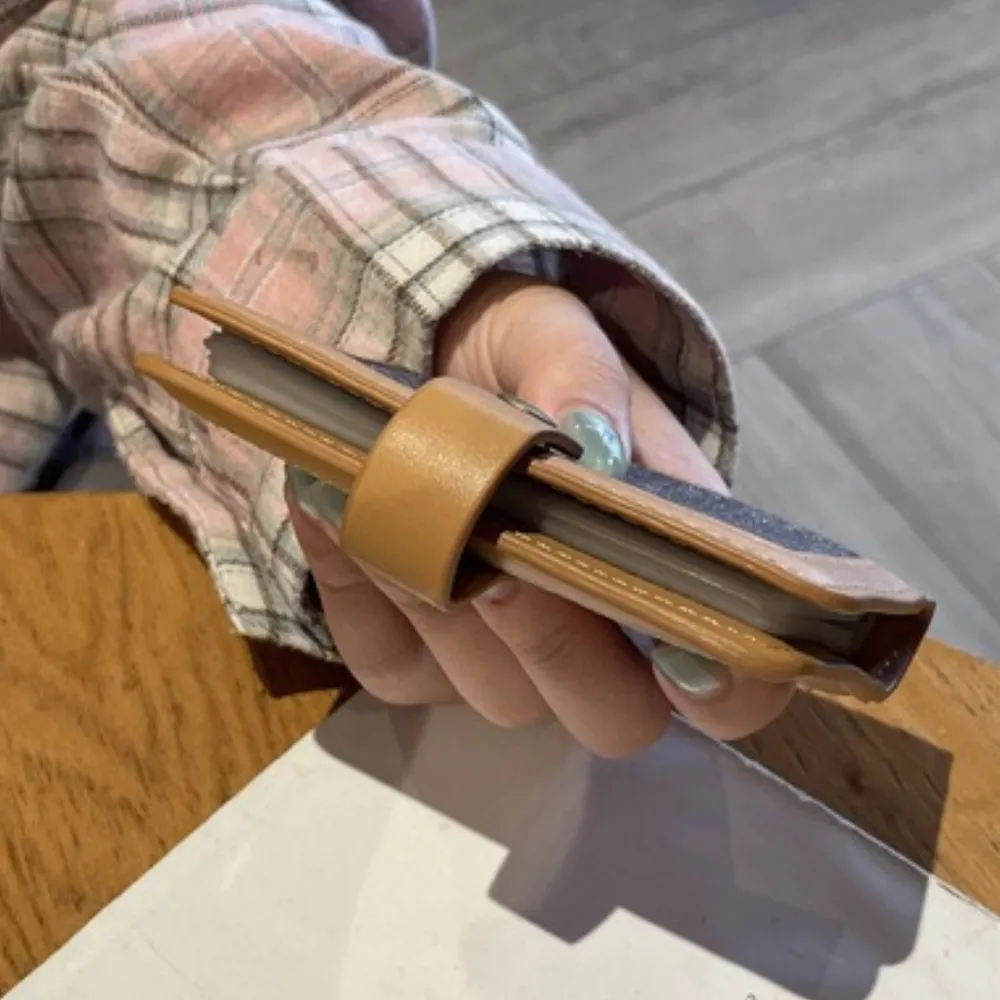 Women's wallet held by hand with compact design