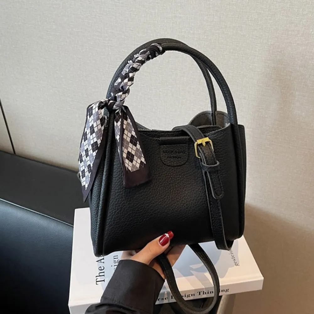 Black crossbody bag with scarf detail and structured design