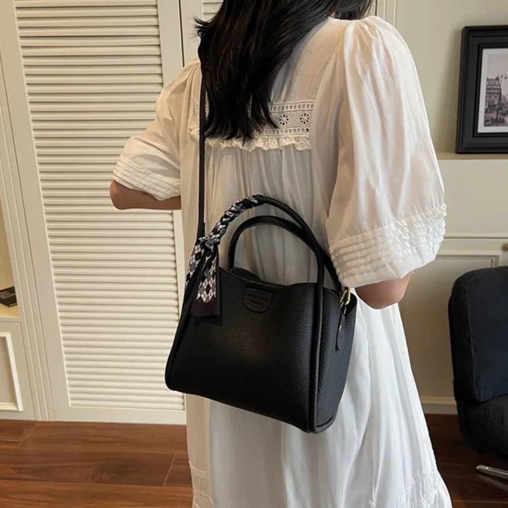 Black crossbody bag styled with a casual outfit